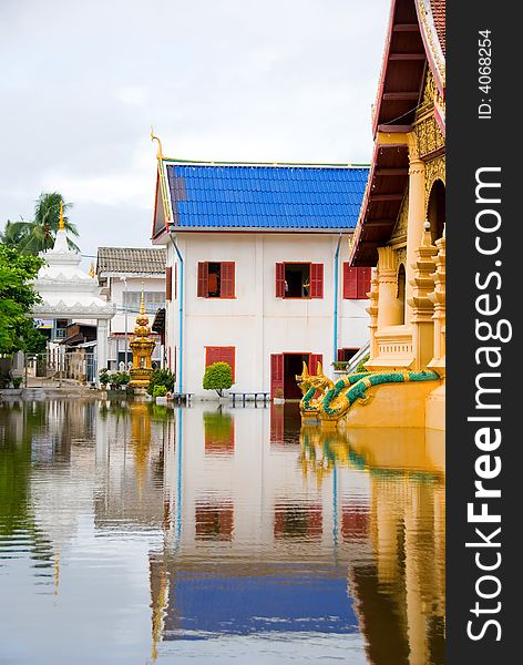 Golden flooded buddhist temple with water reflection