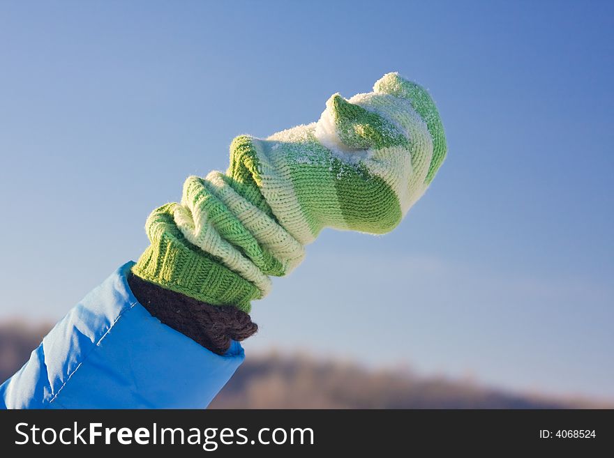 Snow in hand with green mitten. Snow in hand with green mitten