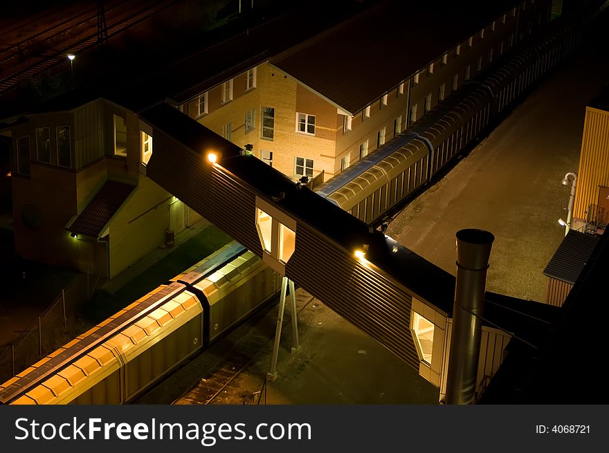 Night photo of a train at a factory building. Night photo of a train at a factory building