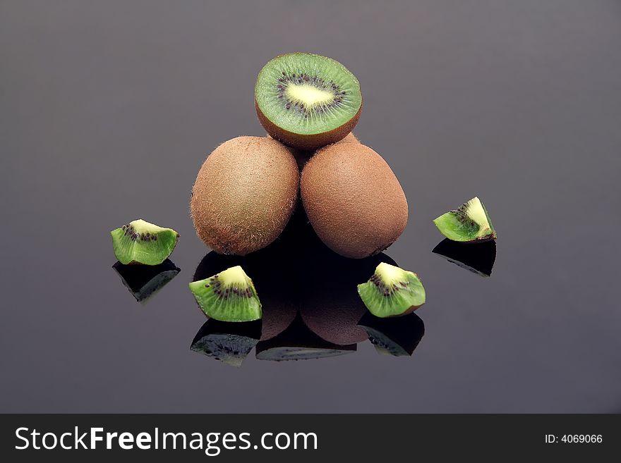 Fresh sliced kiwi on black reflective background