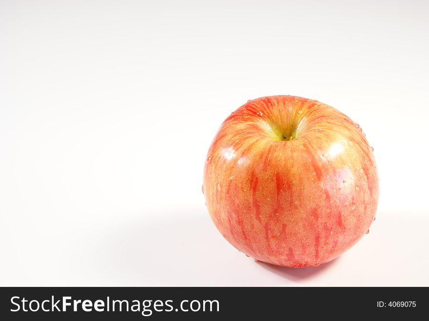 Fresh whole apple with water droplets