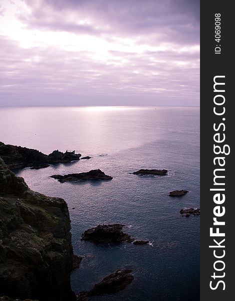 Calm and peaceful seascape with foreground rocks