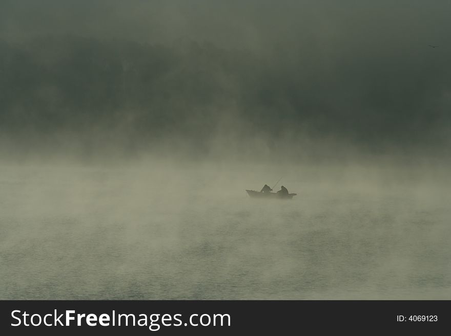 Two Fishermen In Fog Morning
