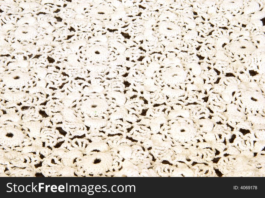 Antique crocheted doily background texture.