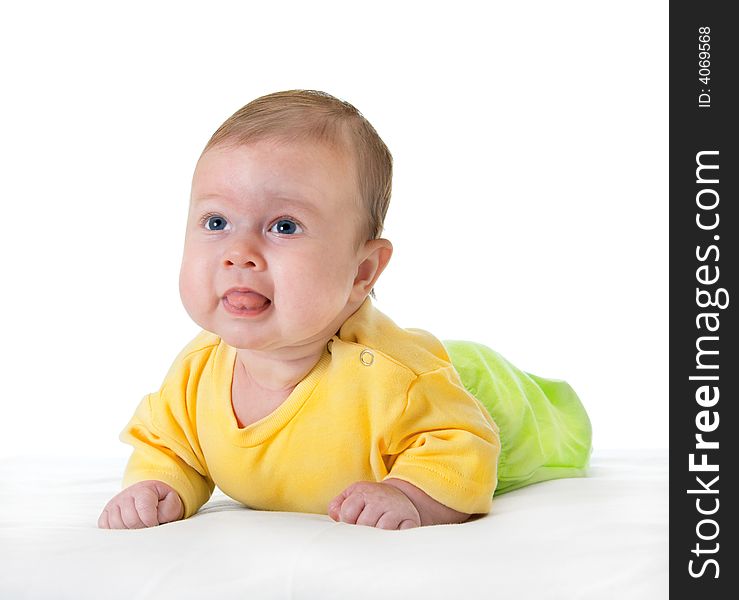 Small smiling baby on table over white