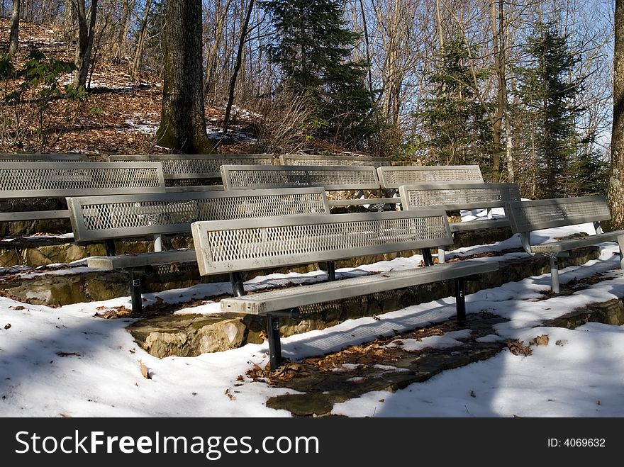 Empty seats in a snowy amphitheater area. Empty seats in a snowy amphitheater area.