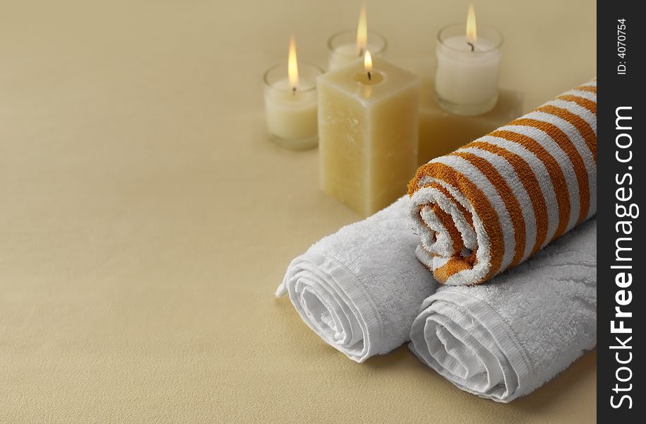 Candles and towels on brown background. Candles and towels on brown background