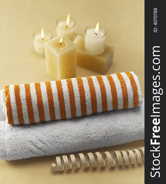 Candles and towels on brown background. Candles and towels on brown background