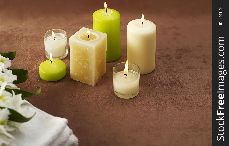 Candles and towels on brown background. Candles and towels on brown background