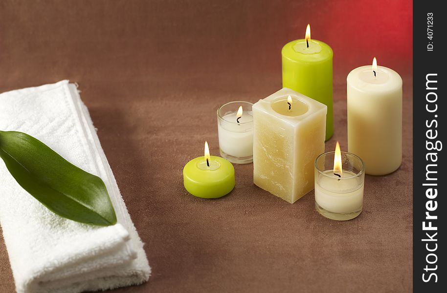 Candles and towels on brown background. Candles and towels on brown background