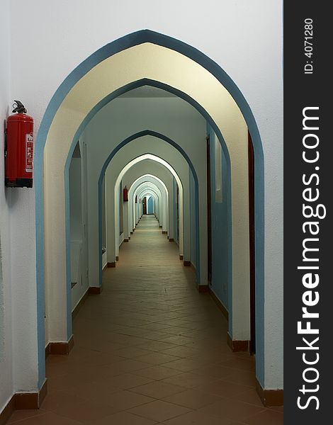 Lancet arch passage in east hotel and fire extinguisher on the wall