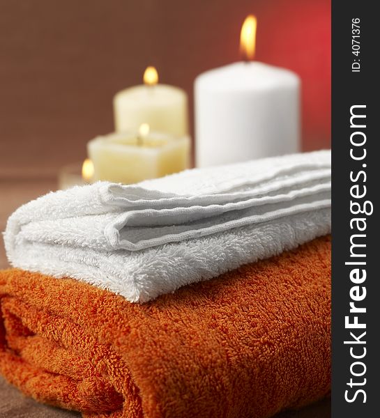 Candles and towels on brown background. Candles and towels on brown background