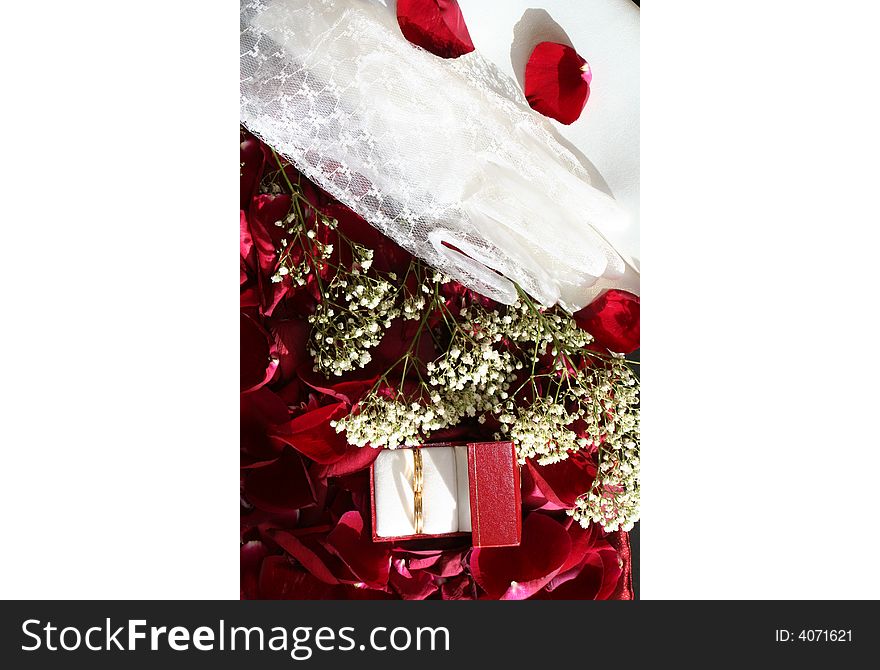 Red sunny background with wedding rings over roses petals. Red sunny background with wedding rings over roses petals