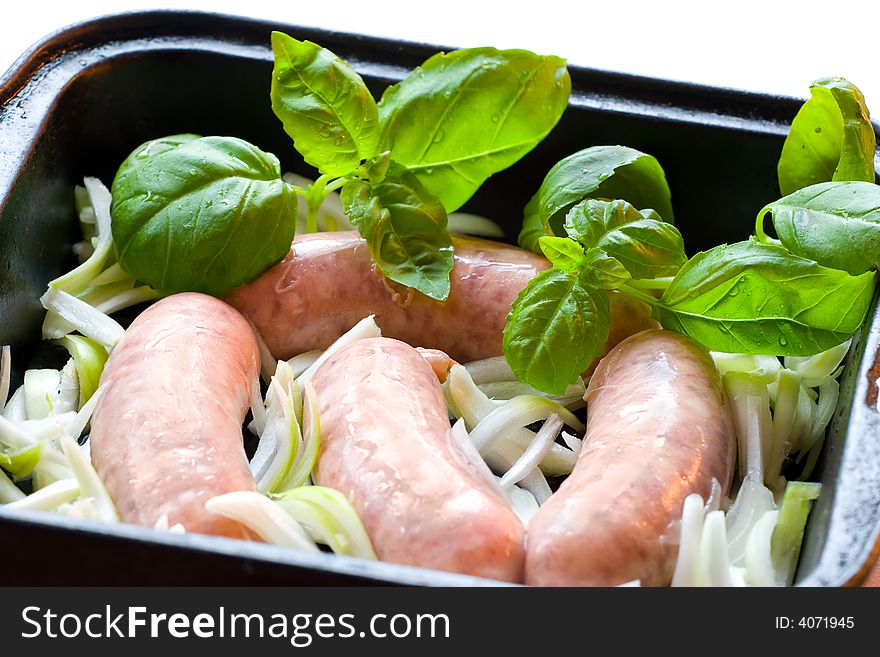 Pork sausages with onion and basil.