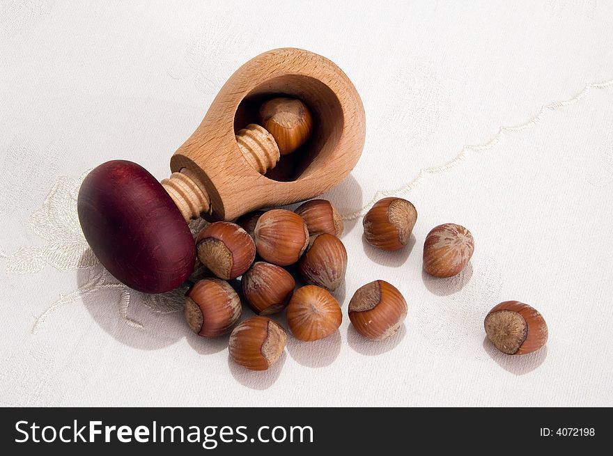 Hazelnuts and screw-cracker on table