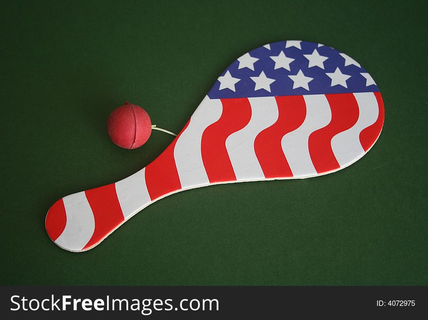 Paddle ball with the American flag over green background