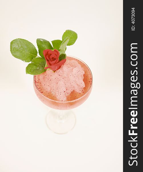 Frozen cocktail with rose decoration and ice