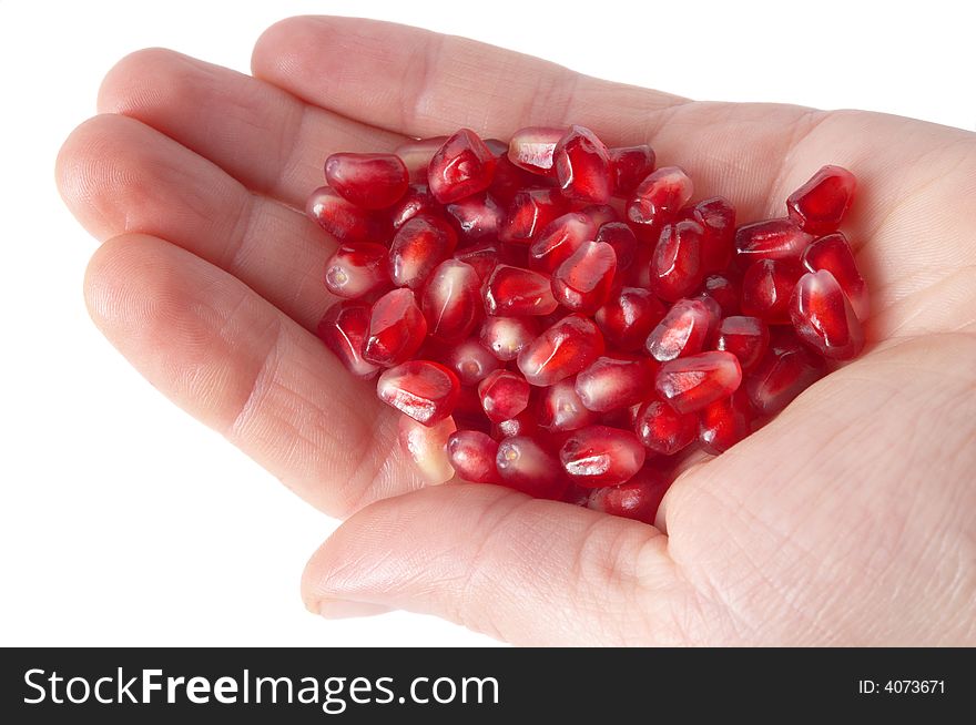 Red ripe pomegranate seeds on the human palm. Red ripe pomegranate seeds on the human palm