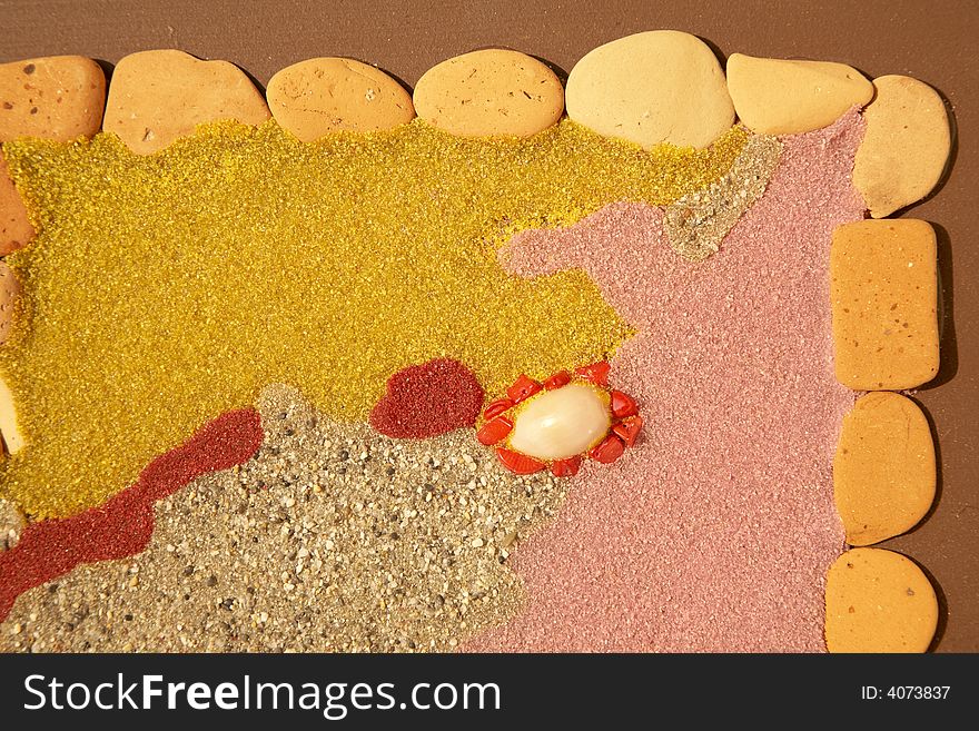 Colourful background: texture created with different kinds of sands, stones, pebbles, gemstone, crystal