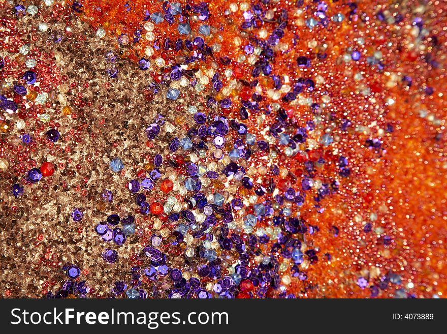 Colourful background: texture created with different kinds of sands, stones, pebbles, gemstone, crystal