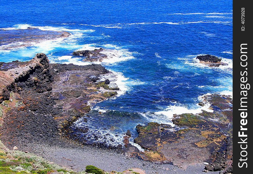 Photograph taken at Cape Schanck looking down the cliffs to the pounding ocean swell (Mornington Peninsula, Australia). Photograph taken at Cape Schanck looking down the cliffs to the pounding ocean swell (Mornington Peninsula, Australia).