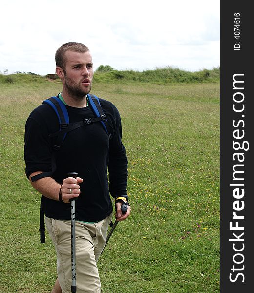 A hiker breathing deeply while walking quickly. A hiker breathing deeply while walking quickly