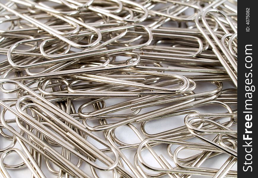 A macro shot of spread out metal paper clips. A macro shot of spread out metal paper clips