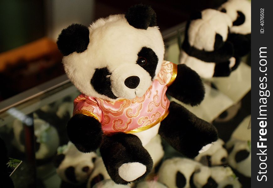 A toy panda wearing a silk shirt