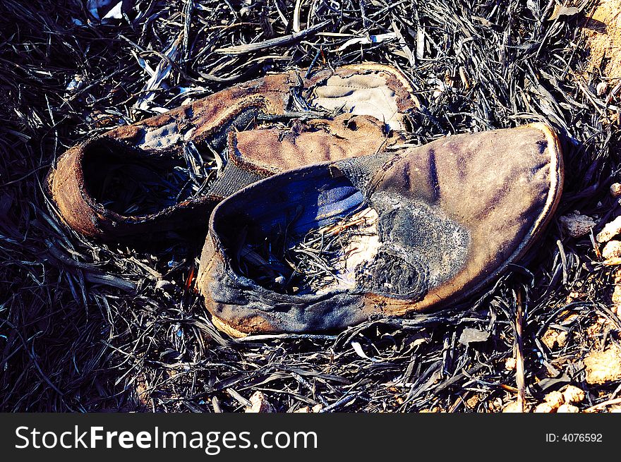 Burned cloth shoes after a field fire. Burned cloth shoes after a field fire