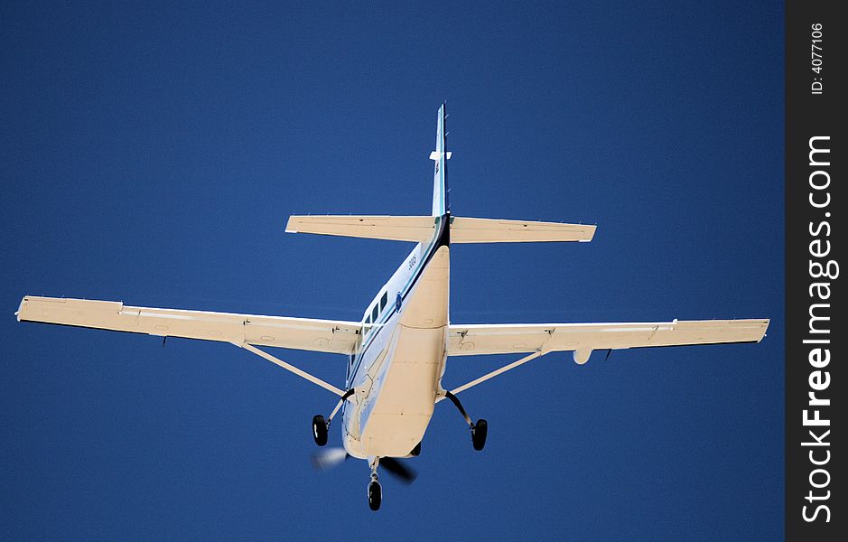 An aircraft coming into land with wheels out on final approach to airport runway. An aircraft coming into land with wheels out on final approach to airport runway