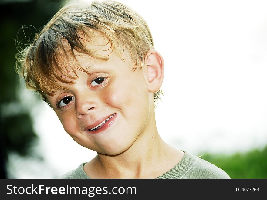 Handsome Boy showing off his perfect smile.  He has blonde hair and brown eyes