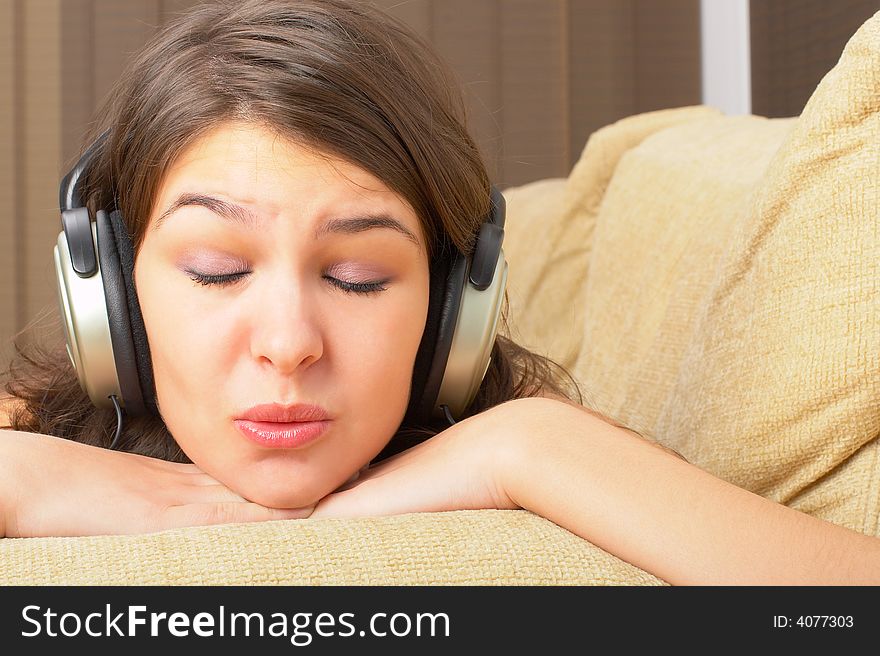 Young Girl enjoys listening music in headphones