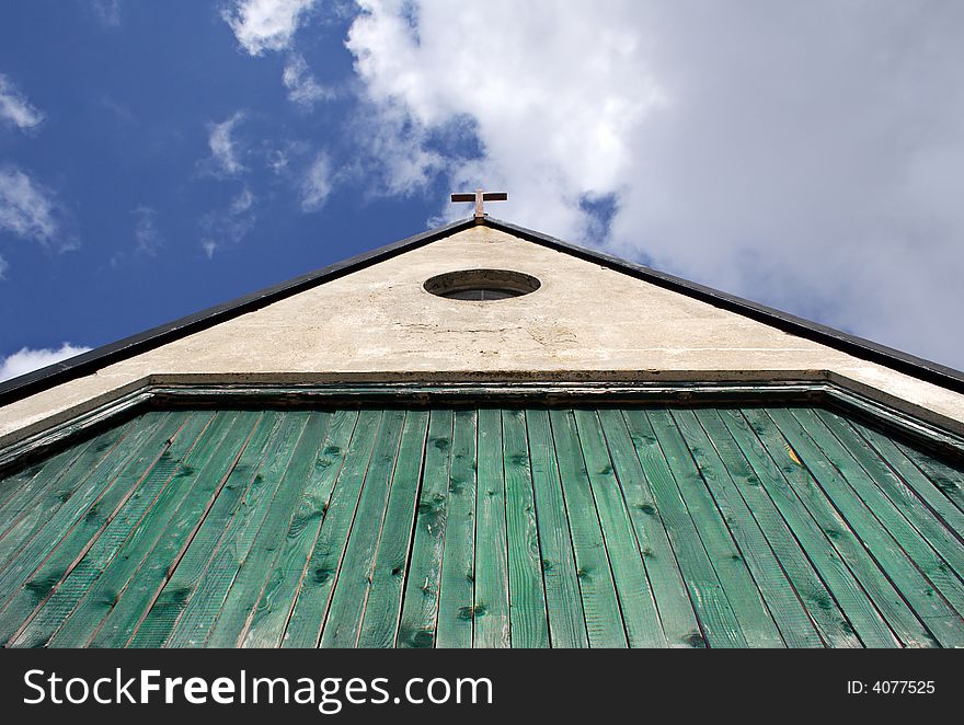 Rural mountain wooden church detail with blue sky background. Rural mountain wooden church detail with blue sky background
