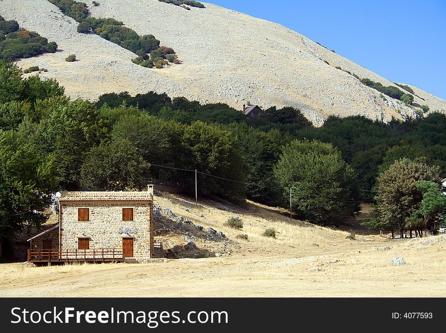 Mountain rural shelter with sky and mountain background. Mountain rural shelter with sky and mountain background