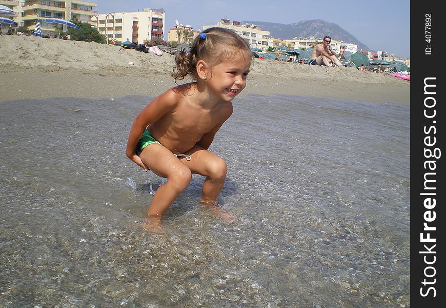 The girl playing on a beach.