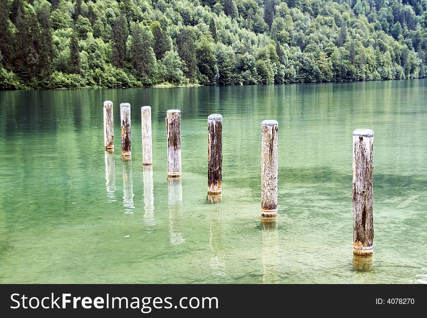 Seven pillars by the lake in the alps. Seven pillars by the lake in the alps