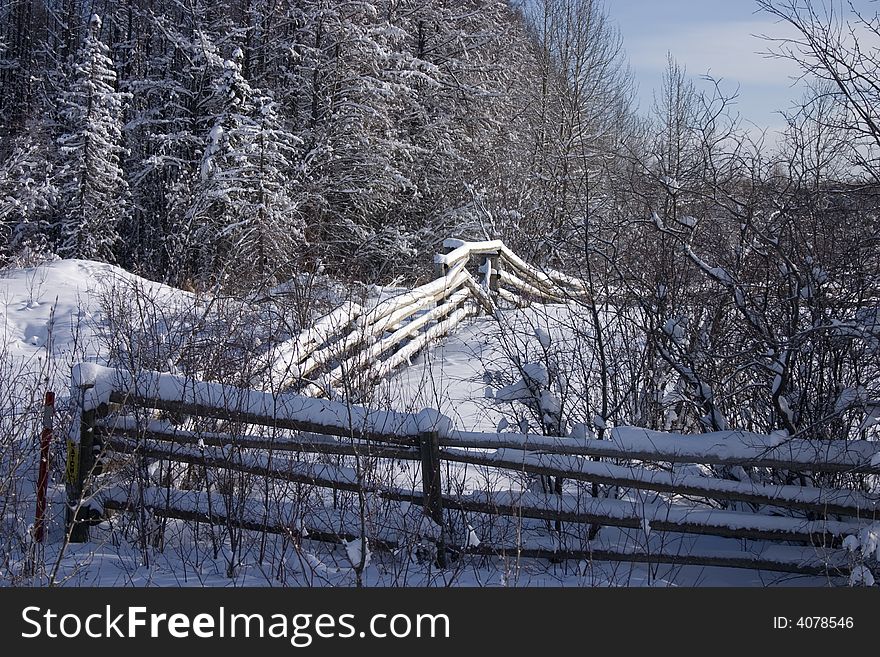 Snow covered fence on a cold winter day. Snow covered fence on a cold winter day.