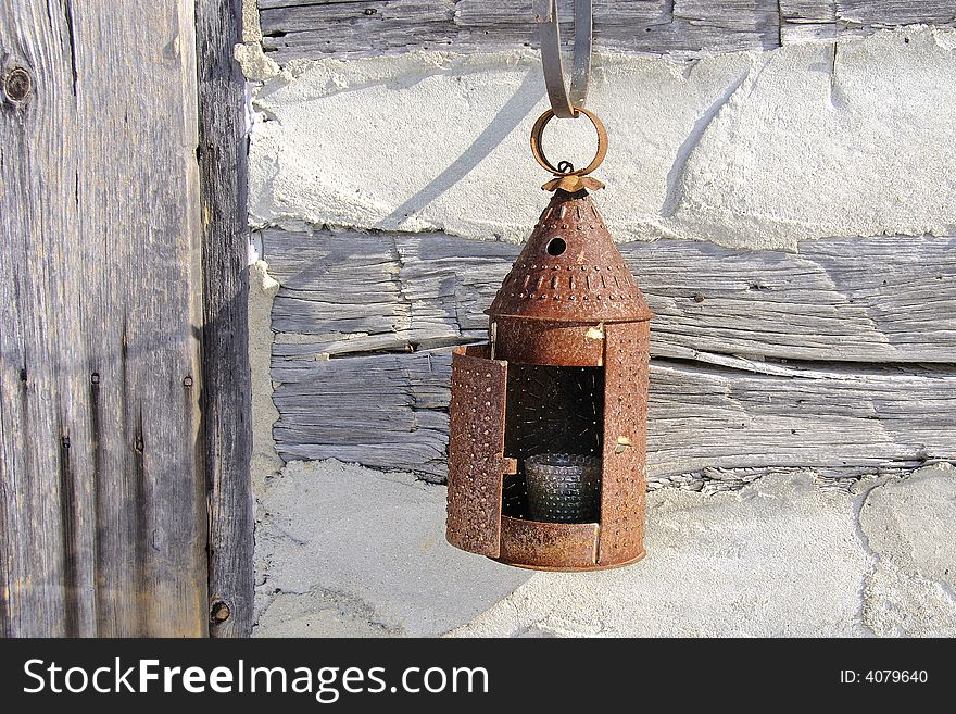 Paul Revere tin lantern hung out side the front door of old log cabin. Beautiful design form simpler times. Paul Revere tin lantern hung out side the front door of old log cabin. Beautiful design form simpler times.