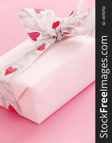 Pink gift box over a pink background