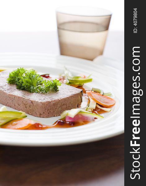 Gourmet game Pï¿½tï¿½ with vegetables and jam on the table