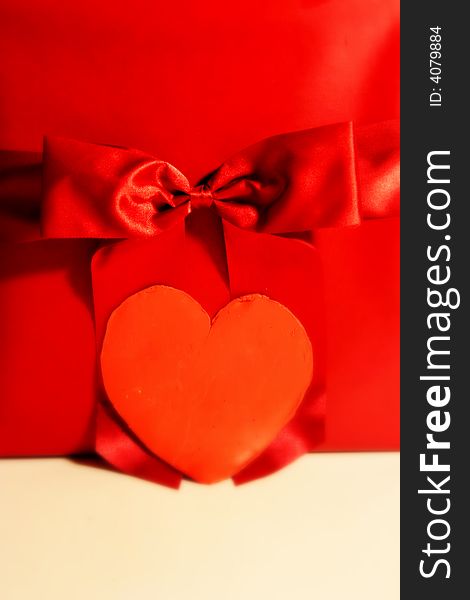 Valentines red gift wrapping with ribbon and heart on white background. Valentines red gift wrapping with ribbon and heart on white background