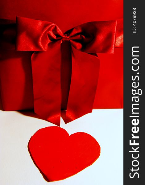 Valentines red gift wrapping with ribbon and heart on white background. Valentines red gift wrapping with ribbon and heart on white background