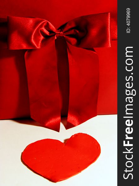 Valentines red gift wrapping with ribbon and heart on white background. Valentines red gift wrapping with ribbon and heart on white background