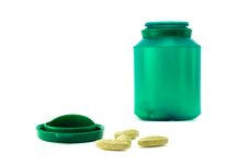 Plastic Green Bottle And Pills Stock Image