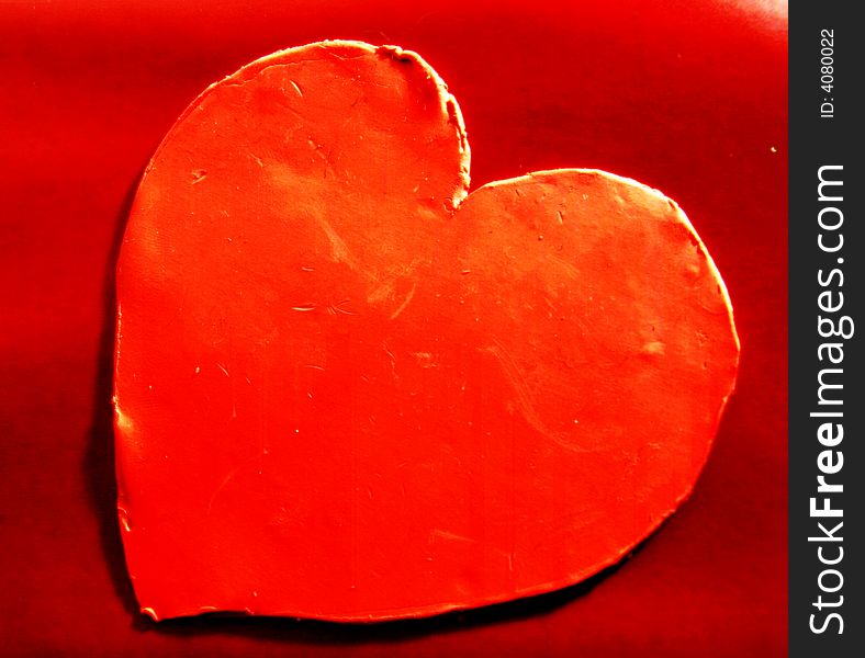 Valentines, red sculpted heart representing to be inloved.  Red background. Valentines, red sculpted heart representing to be inloved.  Red background