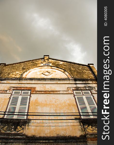 Colonial building with storm clouds