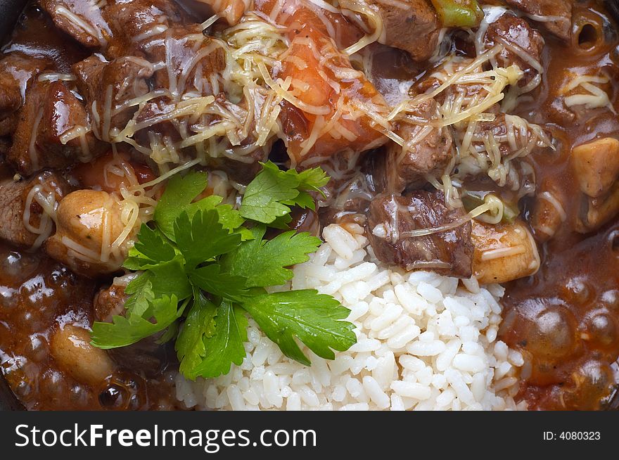 Closeup of boiling goulash with mushrooms and rice