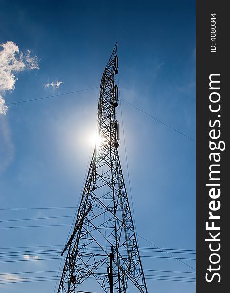 Electric tower with sun and blue sky. Electric tower with sun and blue sky