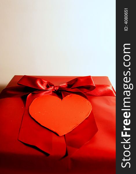 Valentines red gift wrapping with ribbon and heart on white background. Valentines red gift wrapping with ribbon and heart on white background