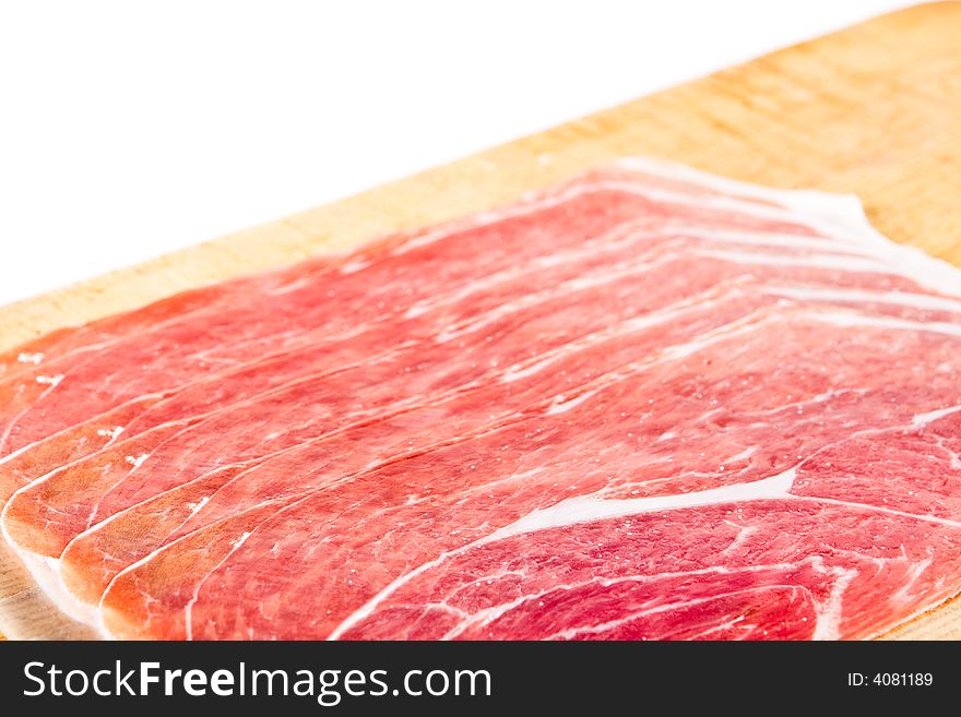 Parma ham on a wooden chopping block